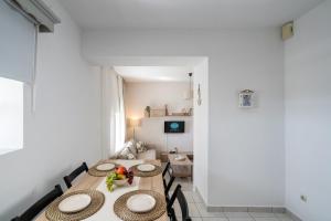a dining room with two tables and a living room at Mesogitonia House in Zekros +21 photos