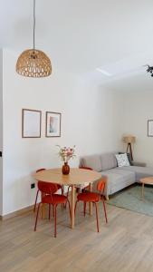 a living room with a table and chairs and a couch at Tashó Simply Living in Xylokastro +5 photos