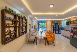 a dining room with a long table and chairs at VIP Garden Villa , Villa private Pool,6BR Near old town in Hoi An