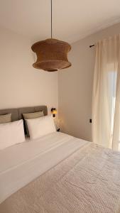 a bedroom with a large bed and a window at Tashó Simply Living in Xylokastro