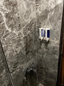 a bathroom with a marble shower with a glass door at Hotel Bergama in Istanbul