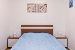 a bedroom with a bed with a blue comforter at Encosta da Cabreira in Vieira do Minho