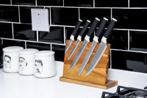 a wooden block of knives sitting on a counter at Real Kee in Midrand