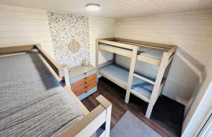 a small room with two bunk beds in it at Vormsi Suvila in Hullo