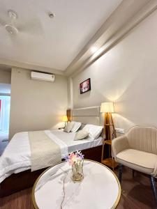a hotel room with two beds and a table at Veloria Grand Suites in Greater Noida