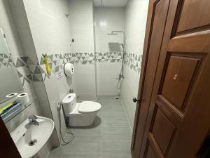 a bathroom with a toilet and a sink and a shower at Khách Sạn Cây Xanh in Da Lat