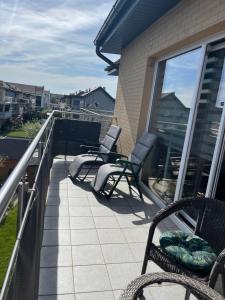 a balcony with two chairs and a railing with a view at Studio Green in Świebodzice