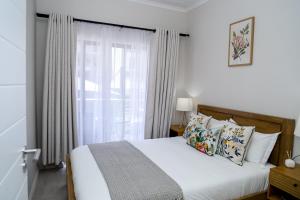 a bedroom with a bed and a large window at Real Kee in Midrand +52 photos