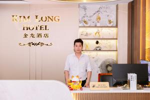a man standing in front of a table in a restaurant at Kim Long Hotel Lao Cai - Near Hekou Border Gate in Lao Cai +9 photos