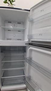 a white refrigerator with its door open with its at Starksway Resort in Calubcub Primero