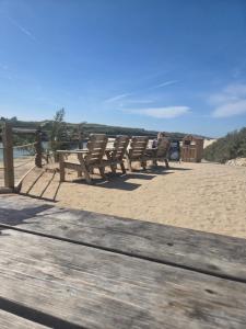 a row of chairs sitting on a sandy beach at 49 Strawberry Hill in Hayle