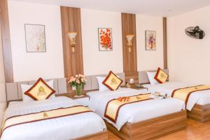 a room with four beds in a room at Kim Long Hotel Lao Cai - Near Hekou Border Gate in Lao Cai