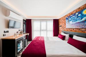 a hotel room with a large bed and a tv at Taksim Artelist Hotel in Istanbul