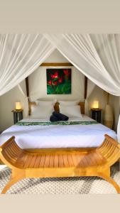 a bedroom with a bed in a tent at Moderne Lodge Tropical in Les Abymes