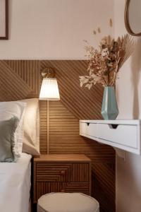 a bedroom with a bed and a vase with flowers at Mesogitonia House in Zekros