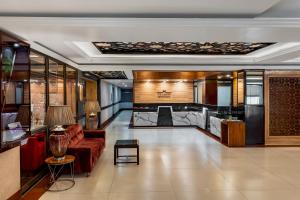 a living room with a couch and a table at The Classic Hotel in Imphal