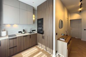 a kitchen with white cabinets and a counter top at NIDO Park view in Daugavpils
