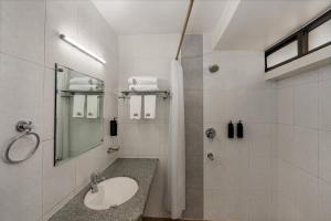 a bathroom with a sink and a shower at The Classic Hotel in Imphal +13 photos