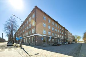 a large brick building on the side of a street at NIDO Park view in Daugavpils