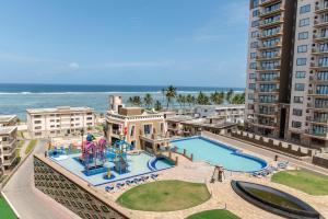 an aerial view of a resort with a water park at Sandy Shore Beach Apartments - Karibu Quarters in Kikambala
