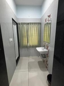 a small bathroom with a sink and a mirror at Richmount Natural Resort Pvt Ltd in Yercaud +10 photos