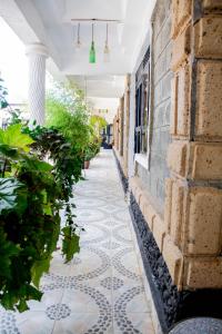 a tiled hallway with plants on the side of a building at Shanny's Cozy Studio in Eldoret