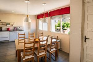 a kitchen with a wooden dining room table and chairs at Piso de Verano en El Tiemblo in El Tiemblo