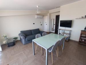 a living room with a table and a couch at B&B Vista Mare "Terrazzo" in Palmi
