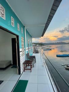 a house with a balcony with a view of the water at Rusde's Komodo Homestay in Pulau Komodo