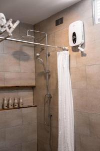 a bathroom with a shower with a shower curtain at Holiday Crib in Dhiffushi +48 photos