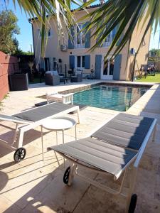 a picnic table next to a swimming pool at LA LIBELLULE de PROVENCE in Morières-lès-Avignon