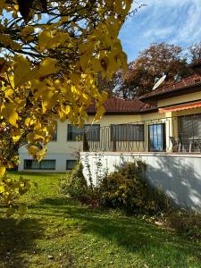 a house with a white fence and a yard at Burgenland Hideaway in Bad Tatzmannsdorf