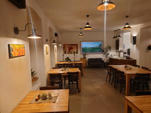 a restaurant with tables and chairs in a room at hostINNec in Dolní Dvořiště +17 photos