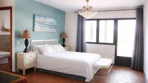 a bedroom with a white bed and a window at Casa Pirinea, Maello, Avila in Maello +19 photos