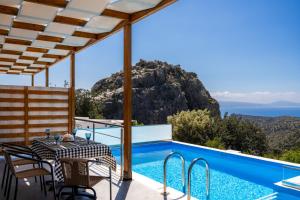 a villa with a view of the ocean at Vrachos Nature Lodges Thyme 1, Private pool in Agia Galini
