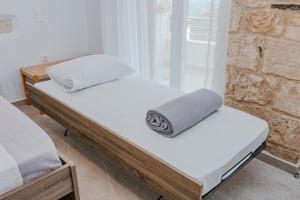 two twin beds in a room with a window at Liopetro in Sitia
