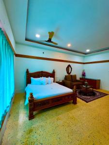 a bedroom with a bed and a couch in it at Richmount Natural Resort Pvt Ltd in Yercaud