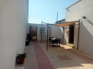 a patio with a table and a canopy on a building at Casa Vacanze da Lui' in Torre Lapillo