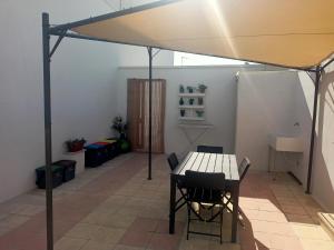a room with a table and chairs under a tent at Casa Vacanze da Lui' in Torre Lapillo