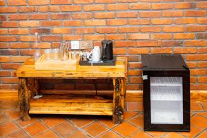 a wooden table with a telephone on a brick wall at Zondela House in Nkoanrua