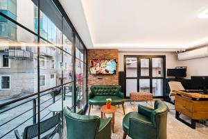 an office with green chairs and a large window at Taksim Artelist Hotel in Istanbul