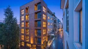 a tall building in a city at night at Taksim Artelist Hotel in Istanbul