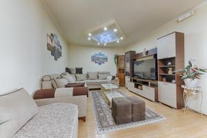 a living room with a couch and a tv at Studio Apartments S in Dobra Voda