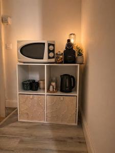 a white shelf with a tv on top of it at Chambre Confort Premium - Monaco 2 in Beausoleil