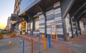 a building with yellow and blue poles in front of it at Ewaa Express Hotel - Yanbu Alamarah in Yanbu