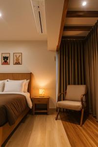 a bedroom with a bed and a chair at Cairo in Siolim