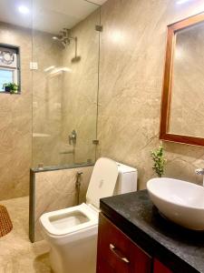 a bathroom with a toilet and a sink and a shower at Cairo in Siolim +9 photos
