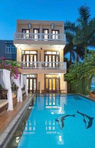 a house with a swimming pool in front of a house at VIP Garden Villa , Villa private Pool,6BR Near old town in Hoi An