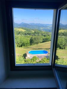 a window with a view of a swimming pool at Villa Doubledot in Piane di Montorio +40 photos