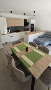 a dining room with a wooden table and chairs at Sunlit Oasis Garden in Postojna +8 photos